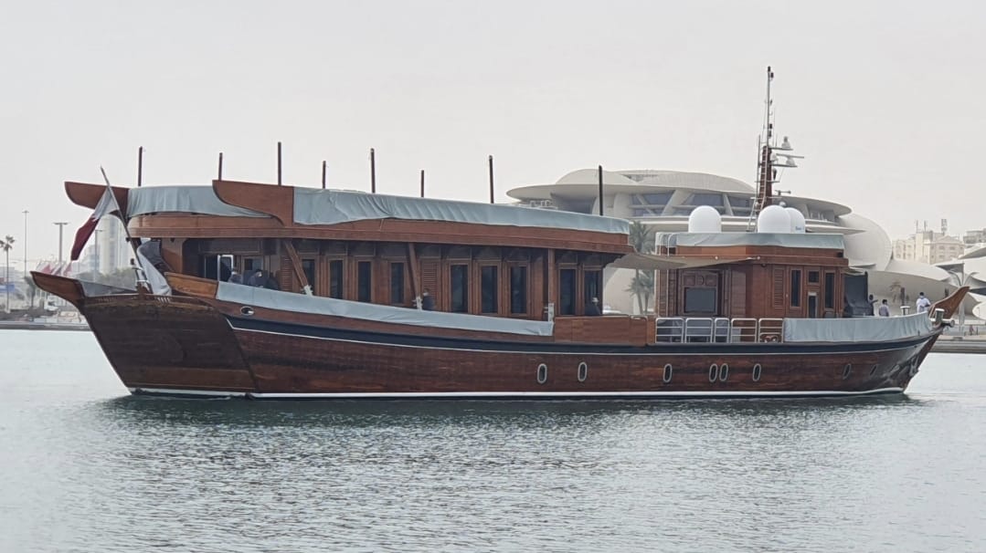 Sambuc traditional wooden dhow with Qatar National Museum behind